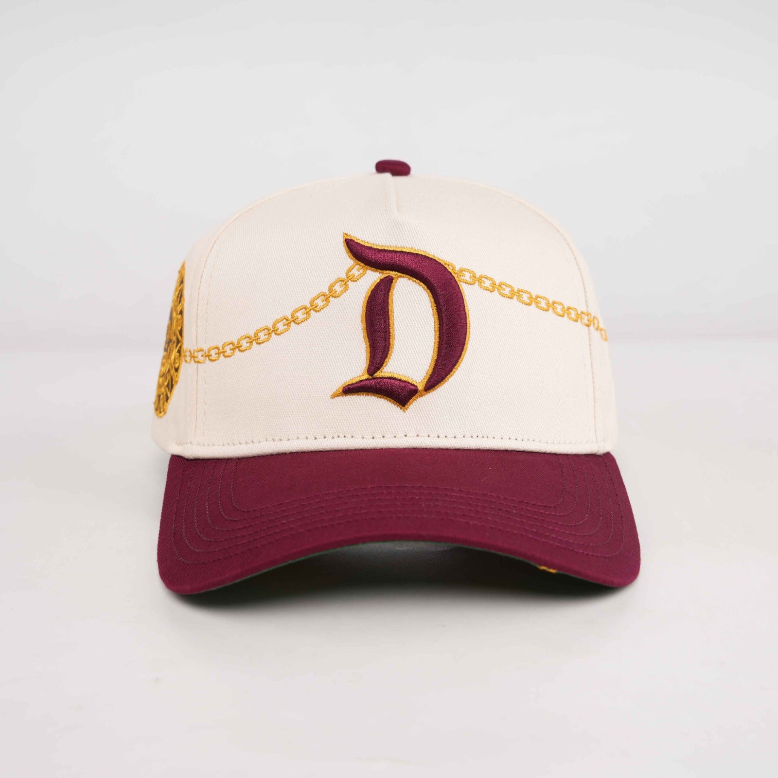 D Chain cream and burgundy snapback hat with old English D embroidery and gold chain detail