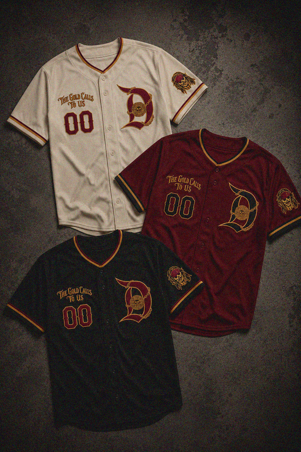 Three baseball-style jerseys laid out on a dark textured background: an off-white jersey with red and gold trim and lettering, a burgundy jersey with red and gold trim and lettering, and a black jersey with red and gold trim and lettering. Each jersey has a large stylized 'D' logo on the chest, 'The Great Call of Us' text, '00' on the front, and a circular sleeve patch.